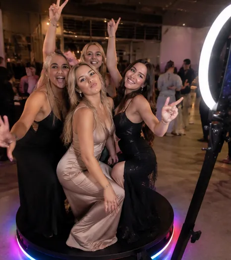 Bridesmaids posing on a 360 photo booth platform