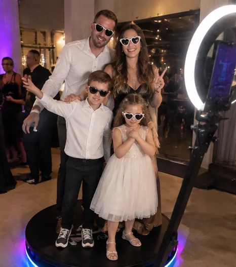 Family with kids in sunglasses on a 360 photo booth