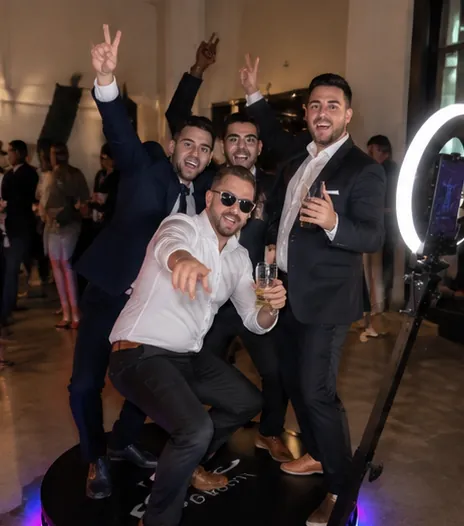 Groomsmen posing on a 360 photo booth platform