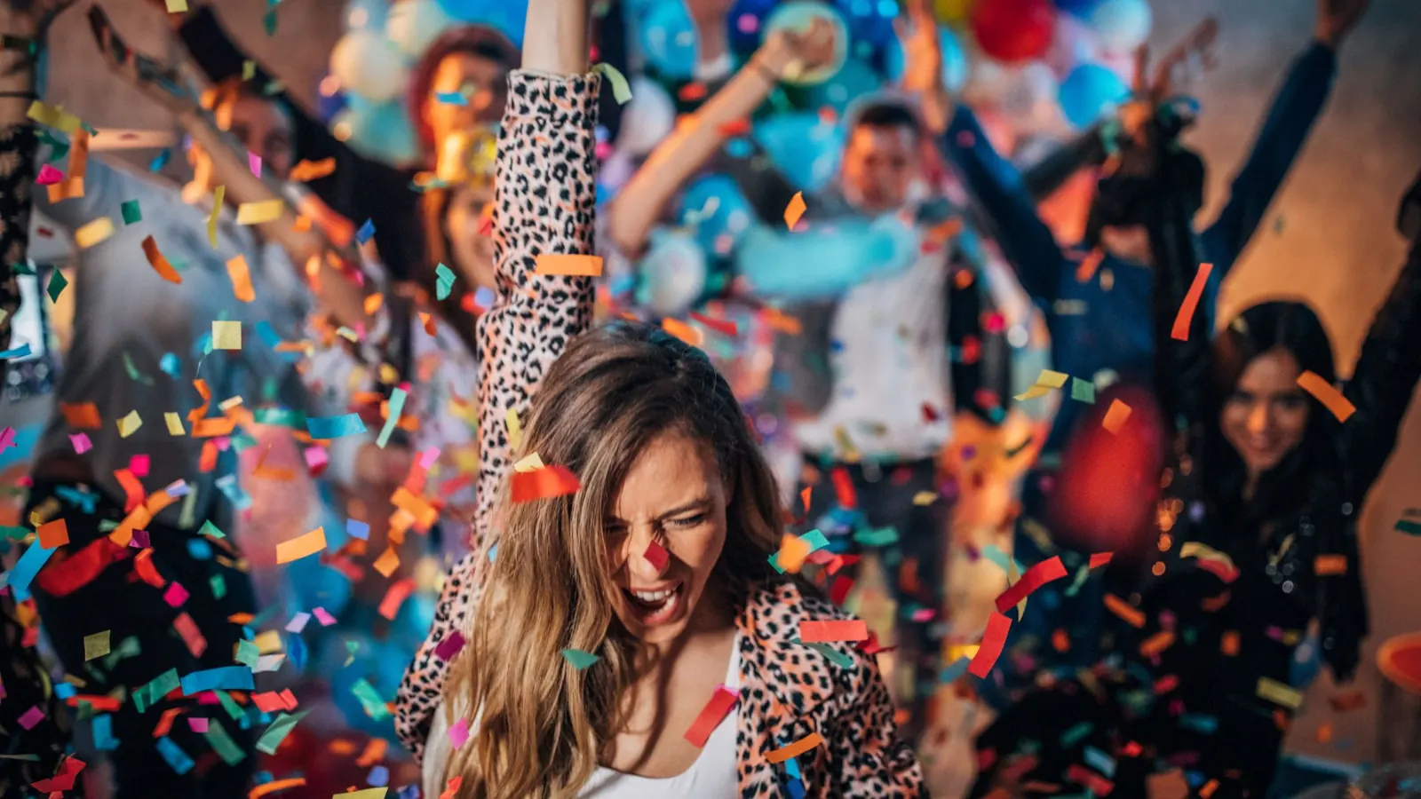 Confetti over a crowd at a photo booth party