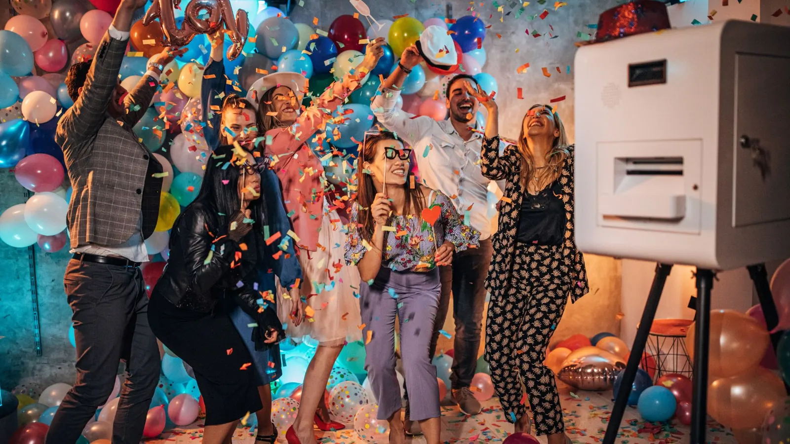 Confetti flying at a party with a photo booth