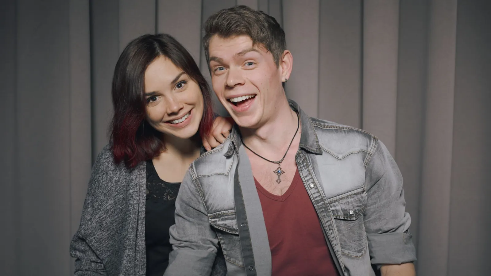 Couple smiling inside a photo booth