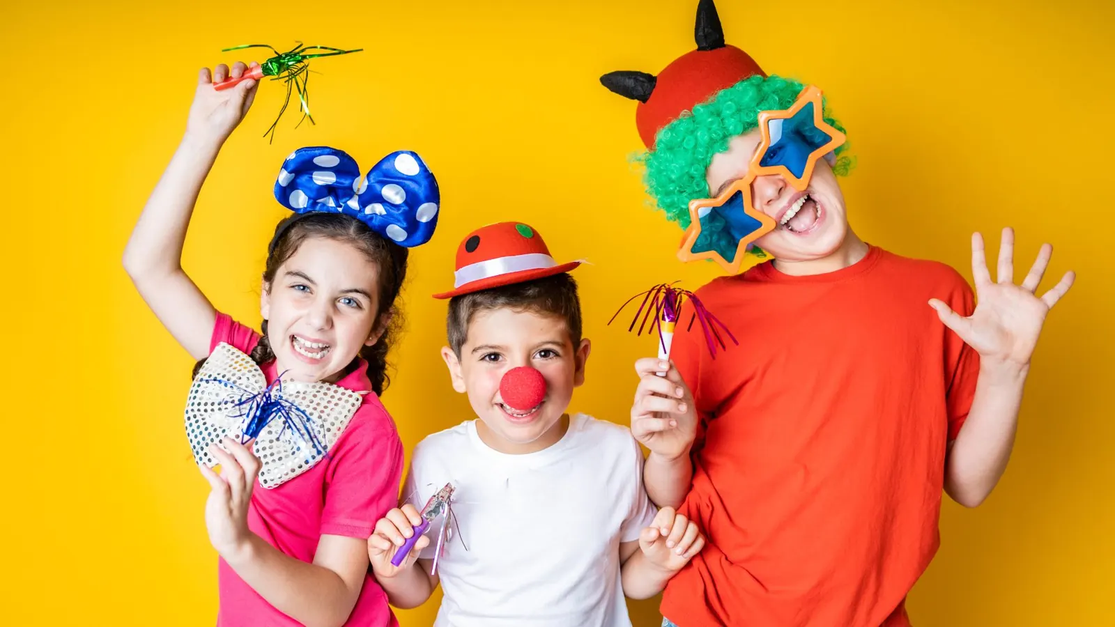 Kids in party hats and props at a birthday photo booth