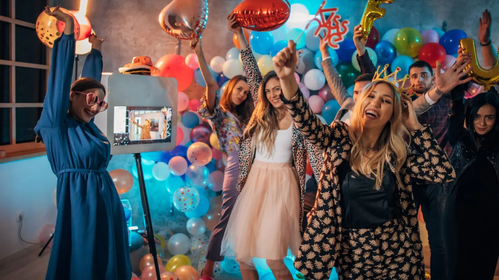 Party guests dancing next to a photo booth